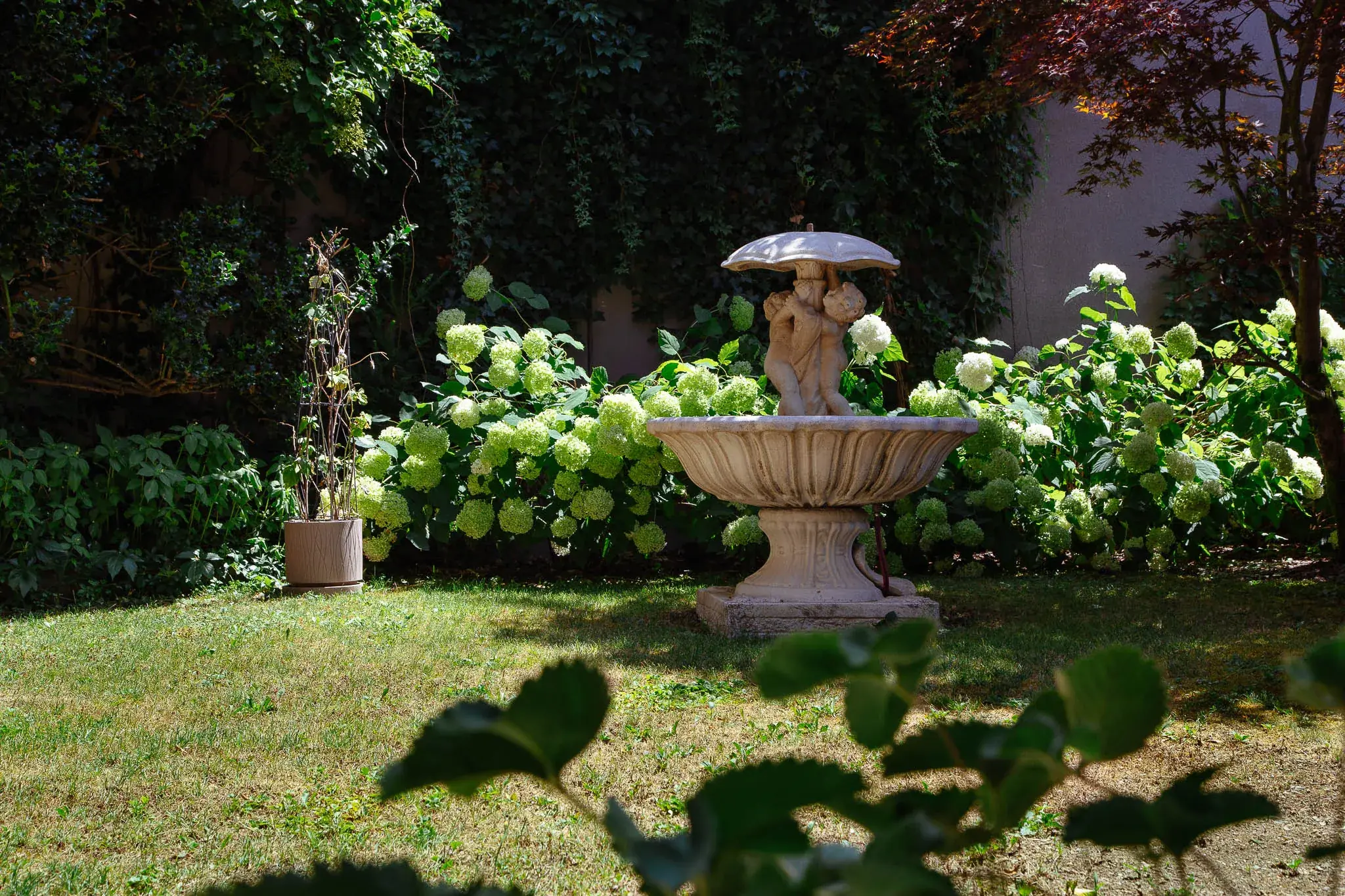 Zahrada hotelu Goritschniggs Hotel s fontánou